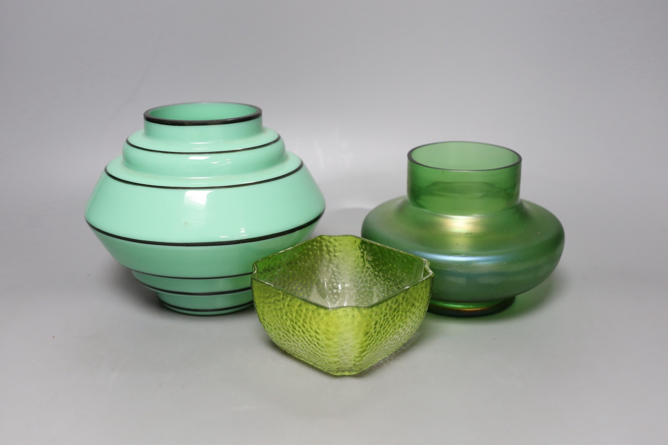 A Michael Powolny style green and black enamelled glass vase and two Palme Konig green glass vessels 14cm